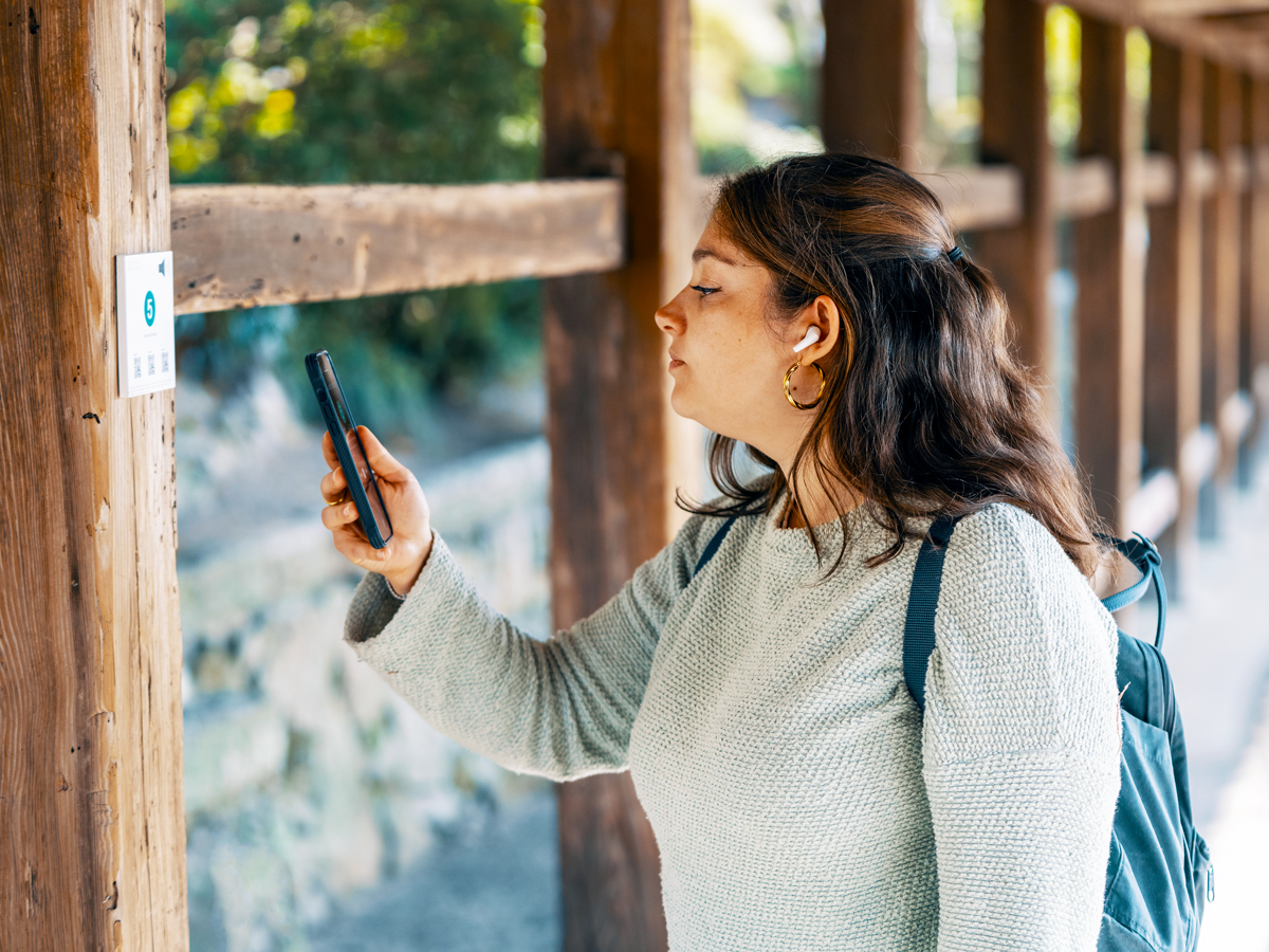Traveler using phone to translate sign