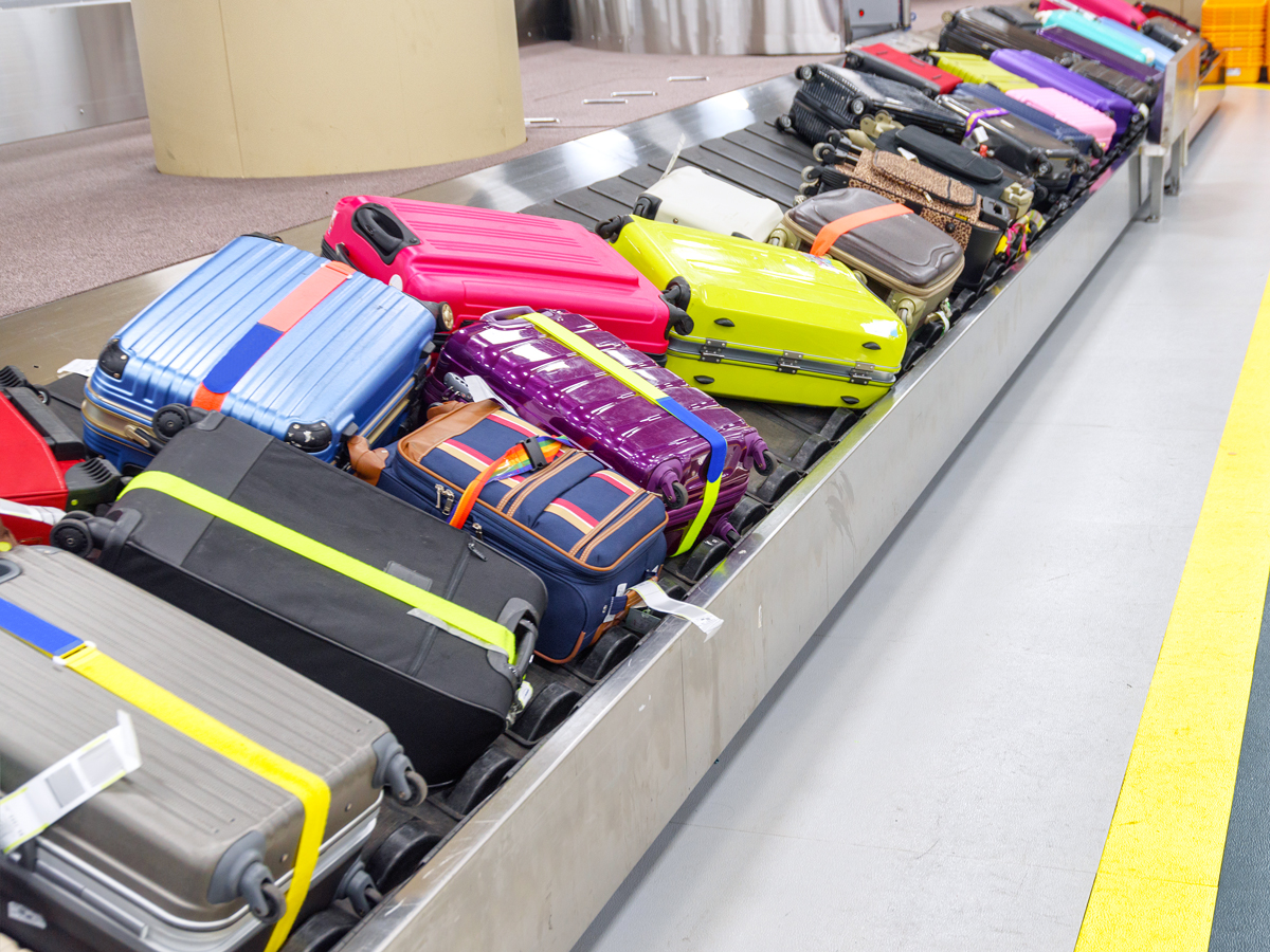Brightly colored bags on airport carousel