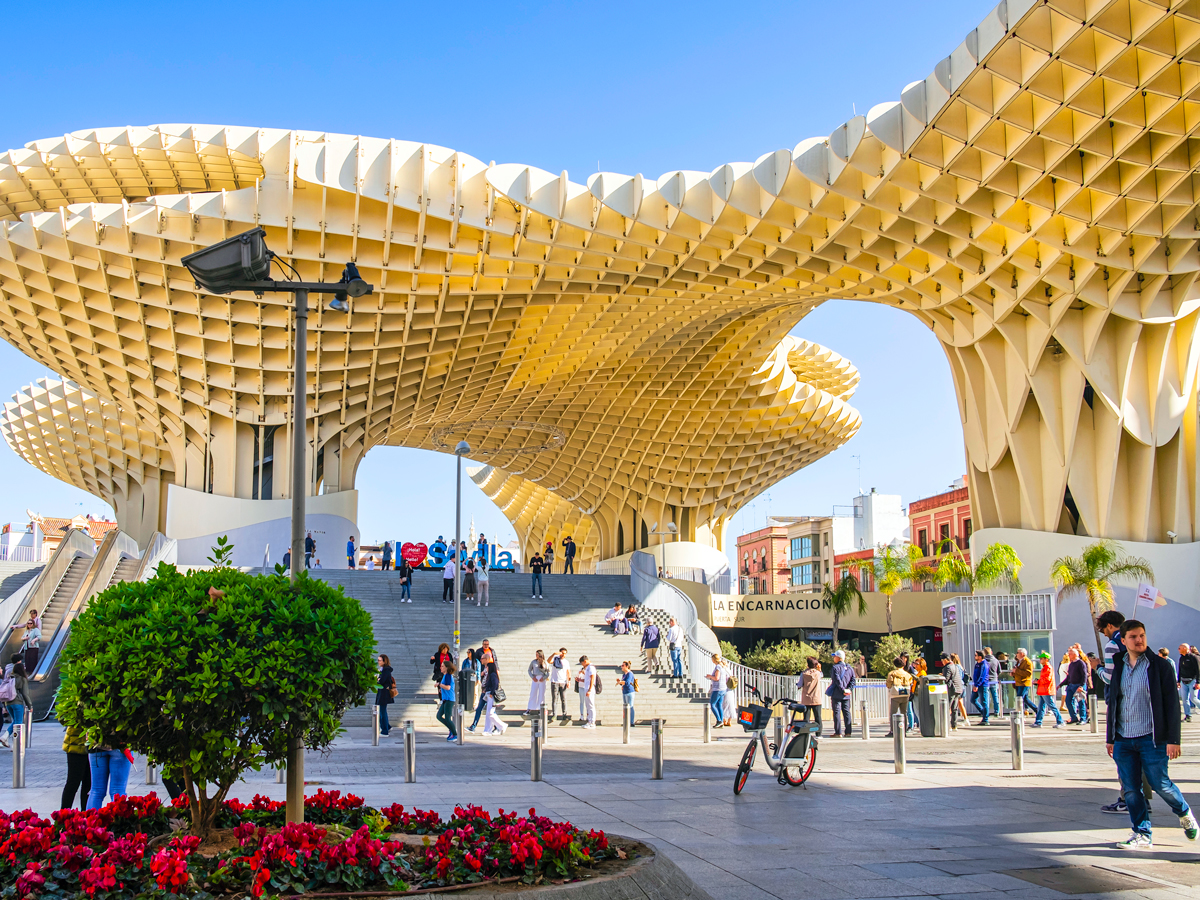 People walking under Setas de Sevilla in Spain