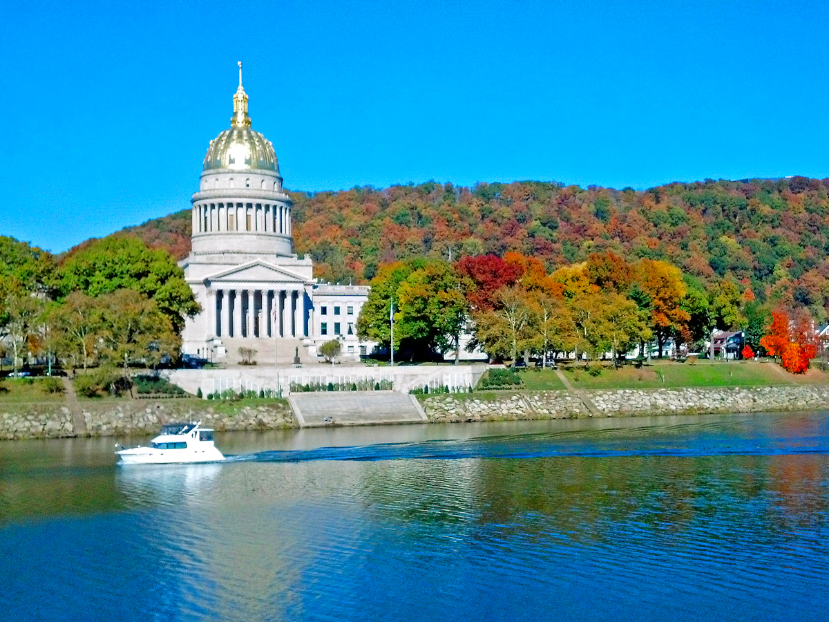 Boat cruising Kanawha River in front of West Virginia State Captiol