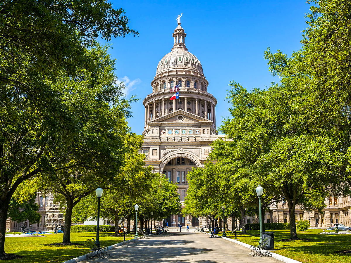 Tree-lined promenade with view of Texas State Capitol dome