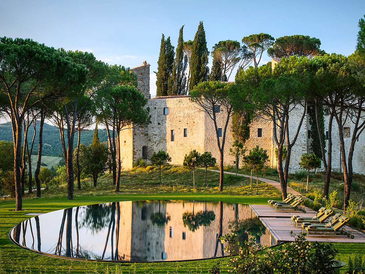Swimming pool reflecting Castello di Reschio in Umbria, Italy