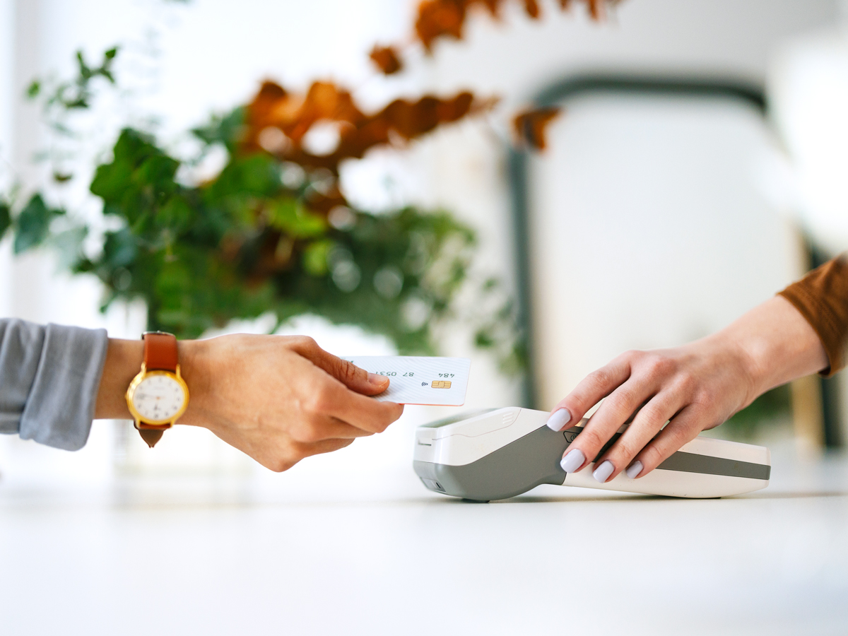 Customer tapping credit card on payment terminal