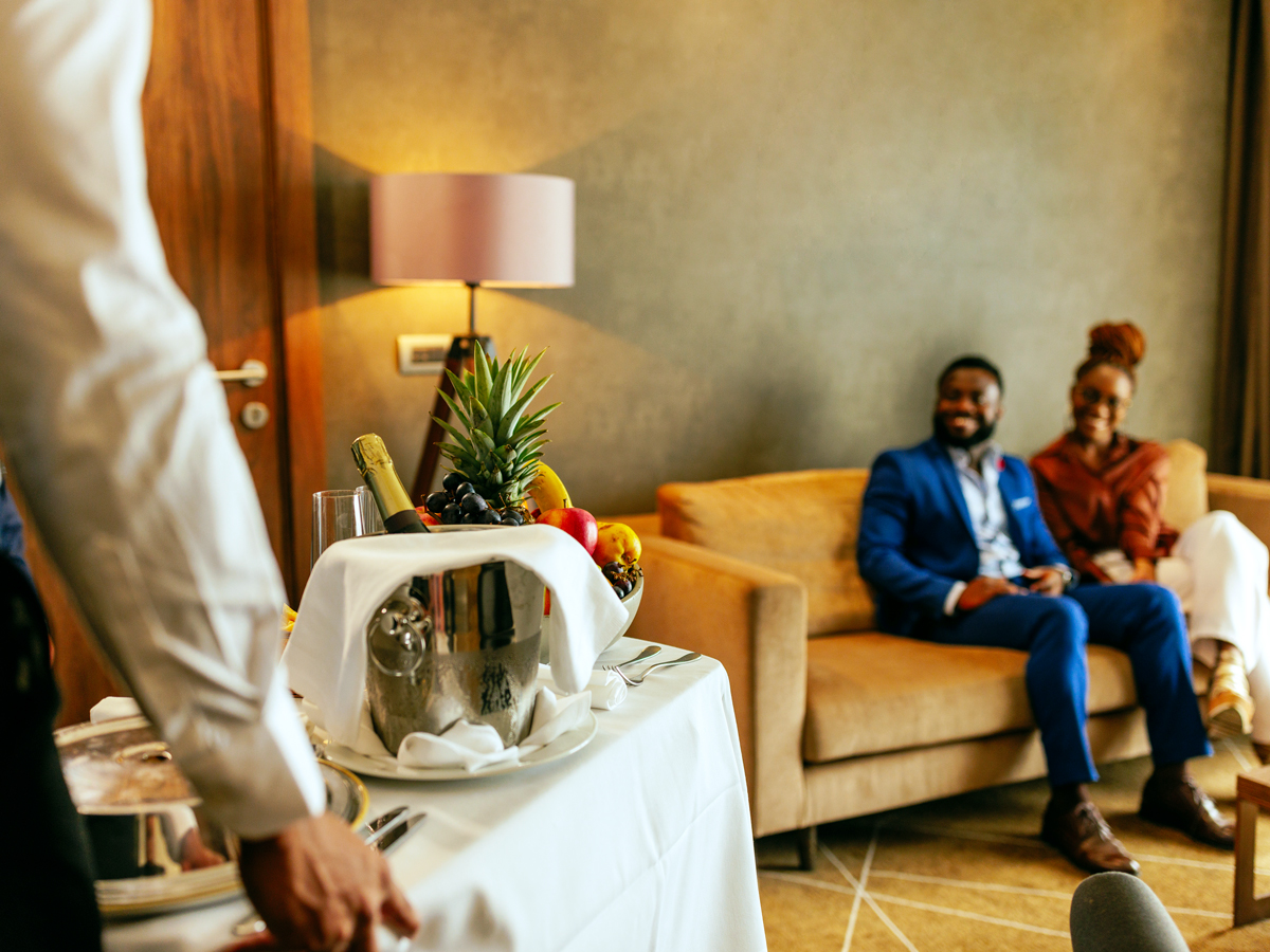 Couple receiving room service delivery at hotel