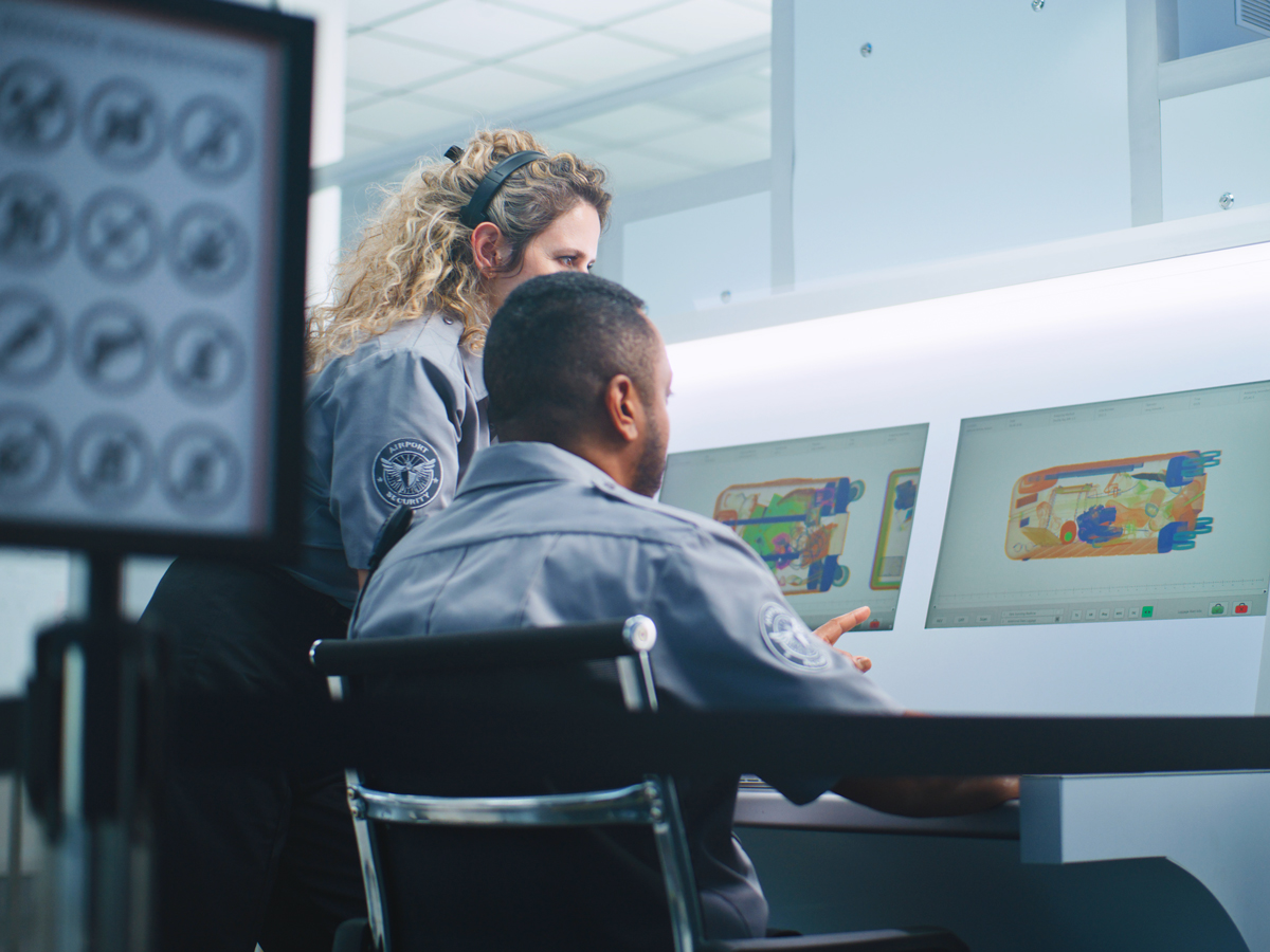 Officers viewing X-ray scans at airport security checkpoint