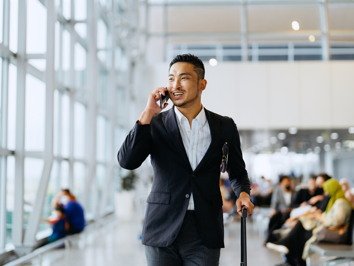Traveler in airport speaking on cellphone
