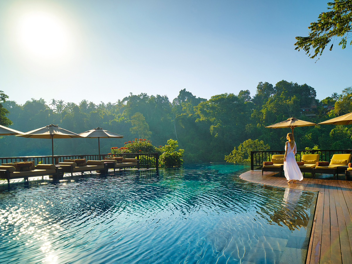 Guest walking by pool at the Hanging Gardens of Bali