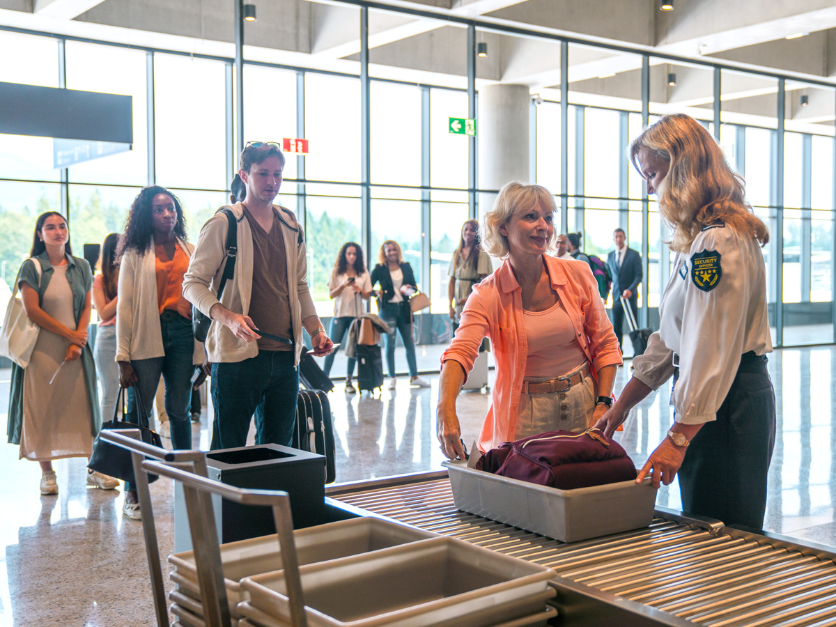 Passengers waiting in line for airport security screening