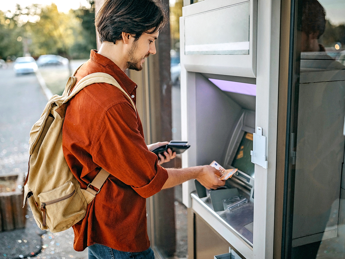 Man taking cash out of ATM