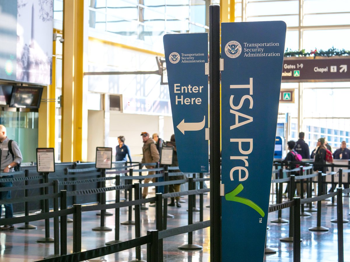 Signs for TSA PreCheck at airport security checkpoint
