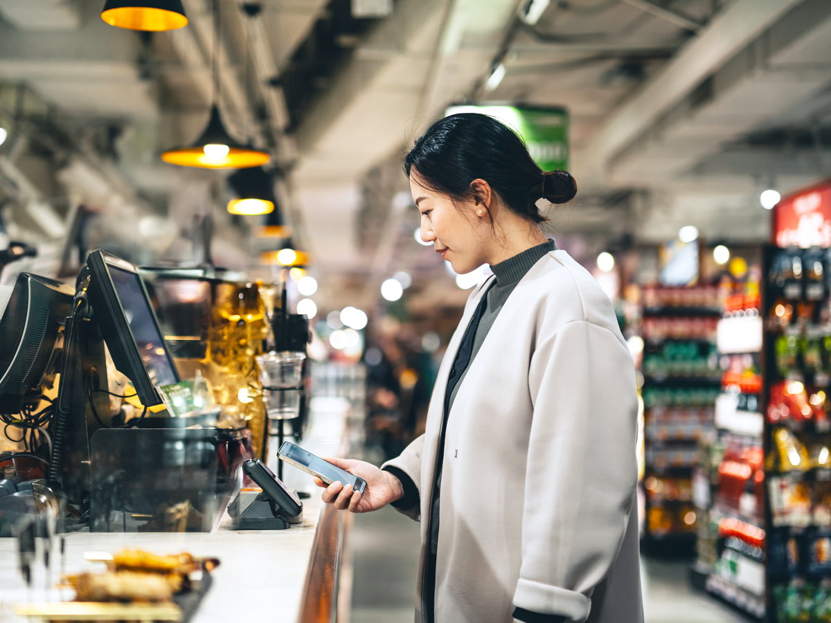Customer using mobile payment option at cash register