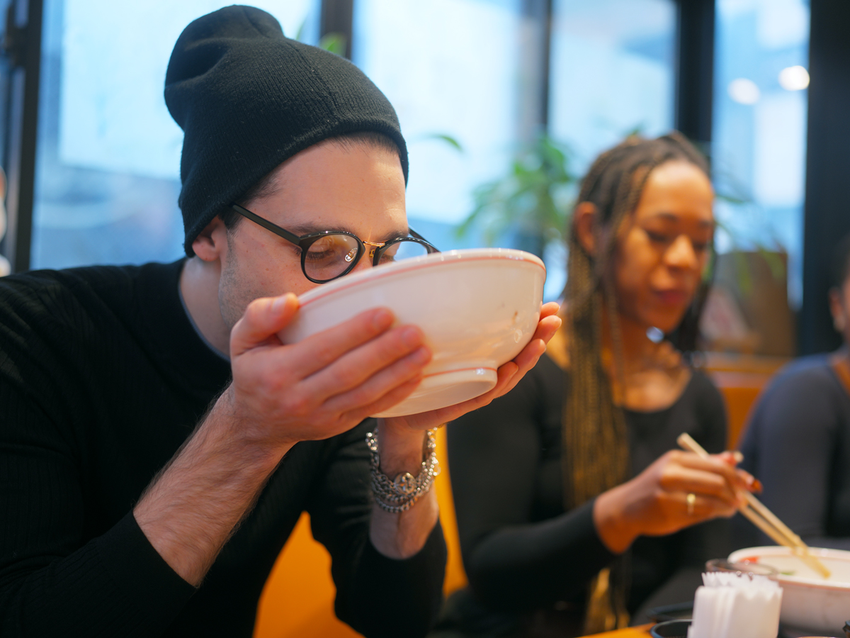 Diner slurping from bowl of noodles