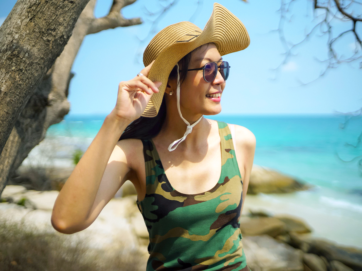 Woman wearing camouflage top at beach