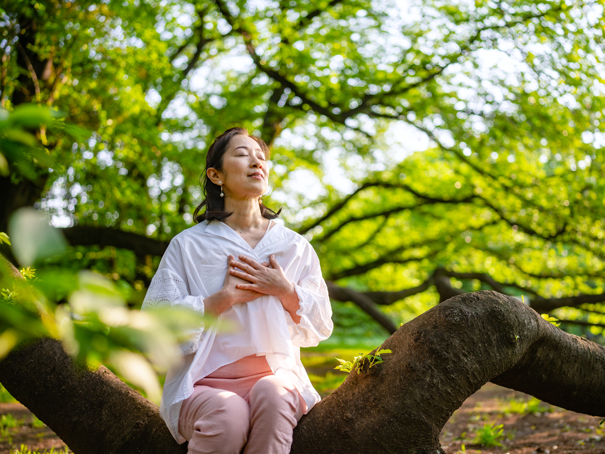 Person meditating in forest