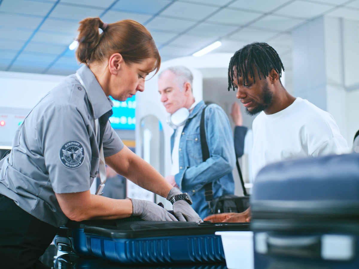 Passengers undergoing security screening at airport