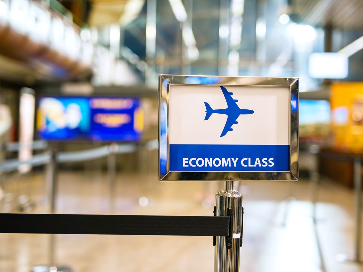 Sign for economy class queue at airport