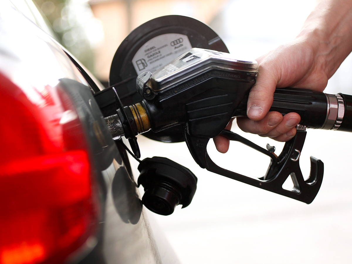 Close-up image of person refilling car gas tank