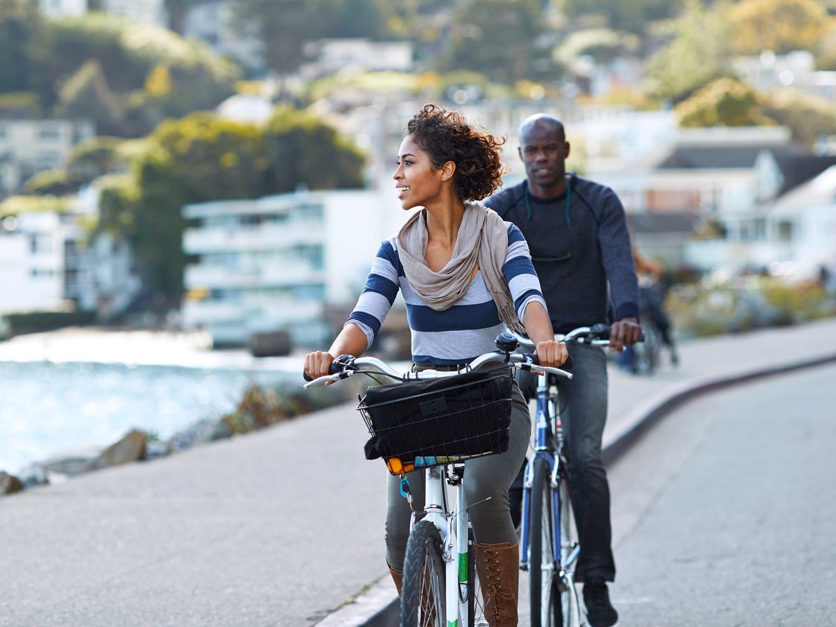 Couple riding bikes in Sausalito, California