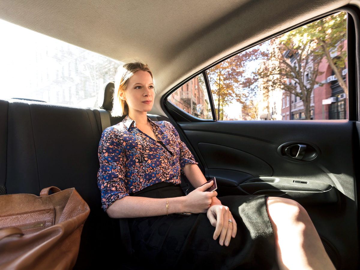 Woman sitting in back of taxi