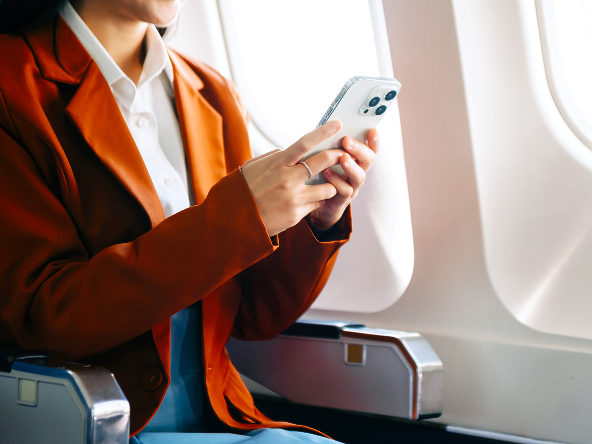 Airline passenger using cellphone