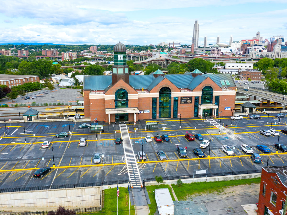 Aerial view of Albany-Rensselaer station with Albany skyline in background