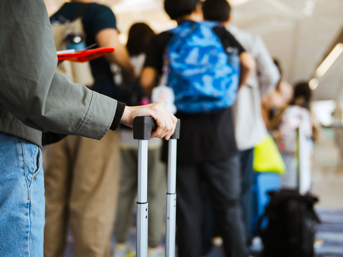 Travelers lining up at airport