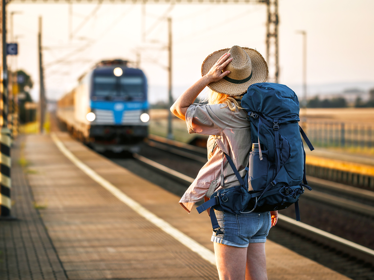 Traveler with backpack waiting on train platform