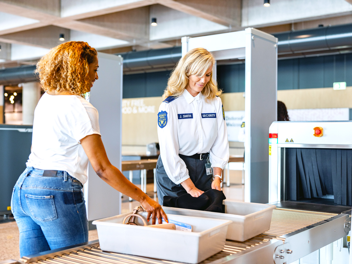Traveler passing through security screening checkpoint at airport