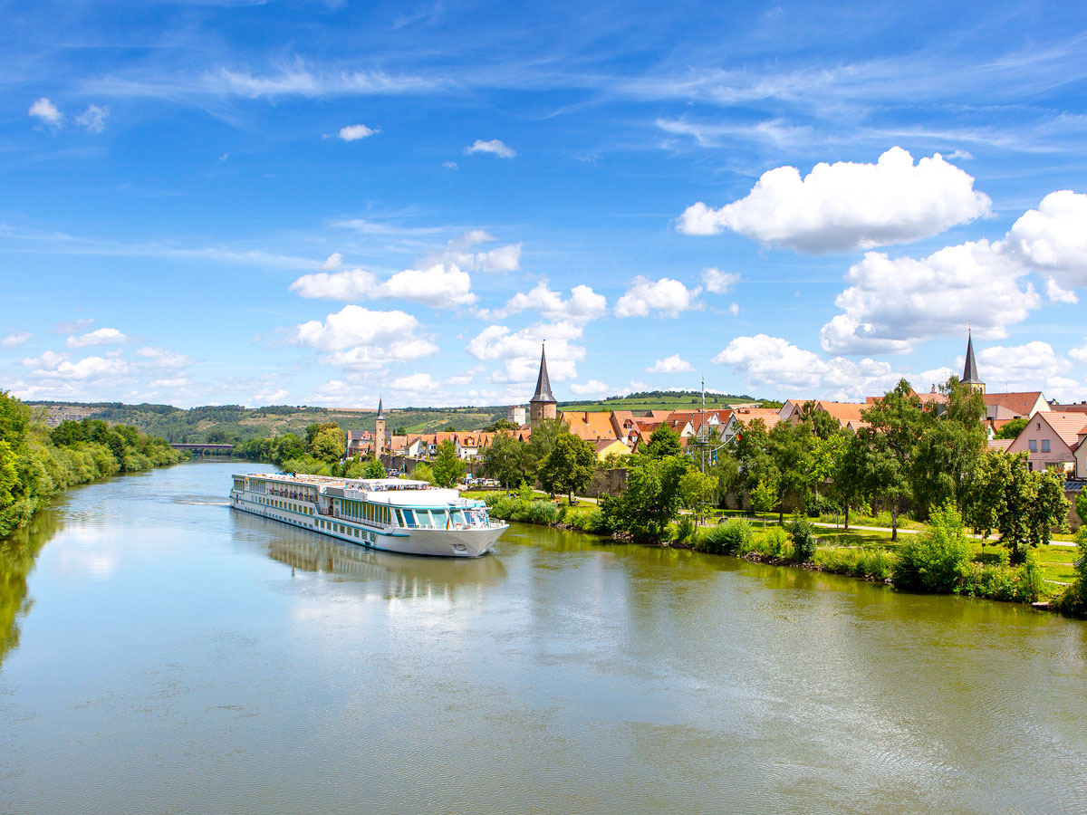 European river cruise under partly cloudy skies