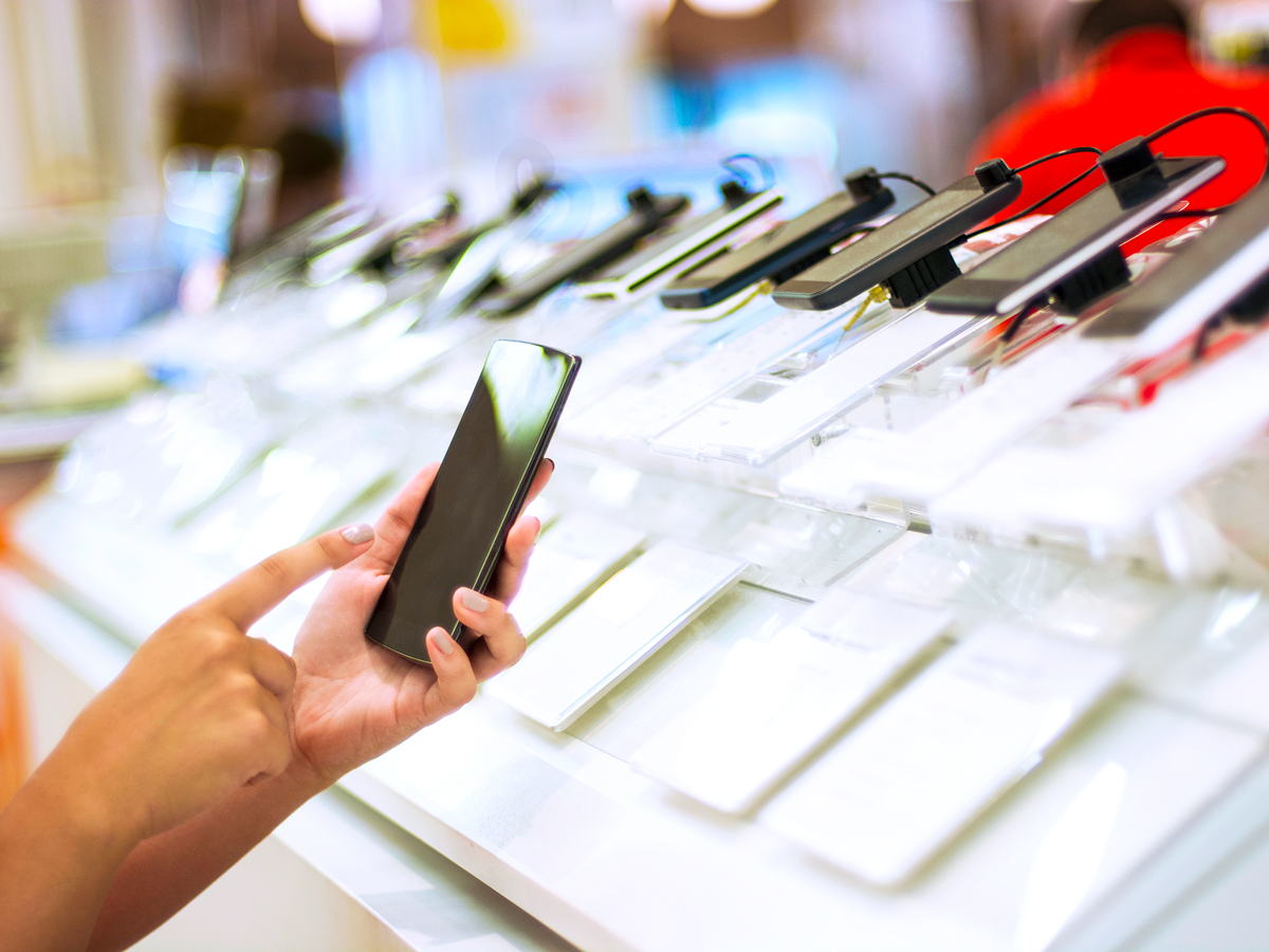 Shopper browsing cellphones at store