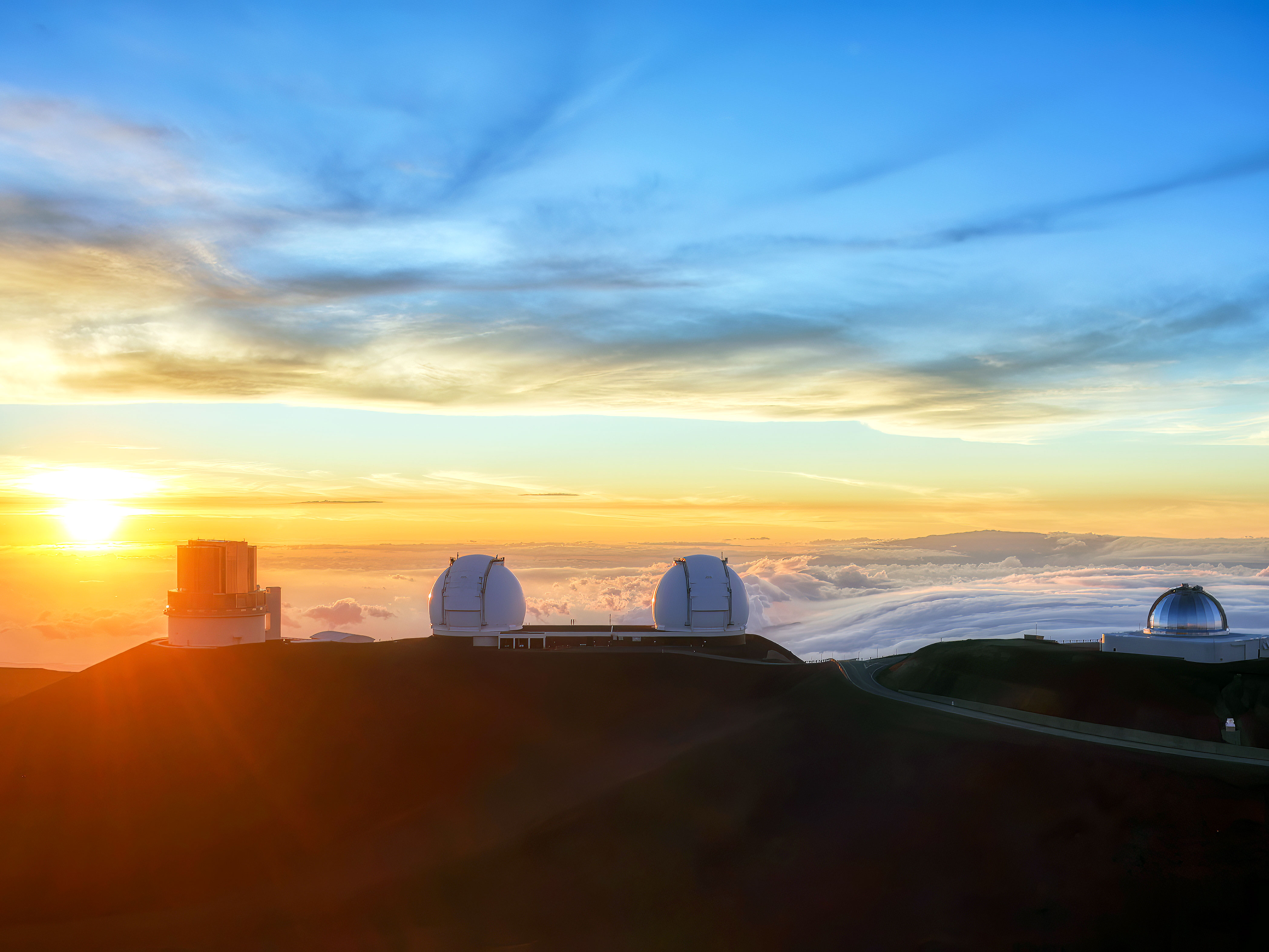 Sun rising over Mauna Kea Observatory in Hawaii