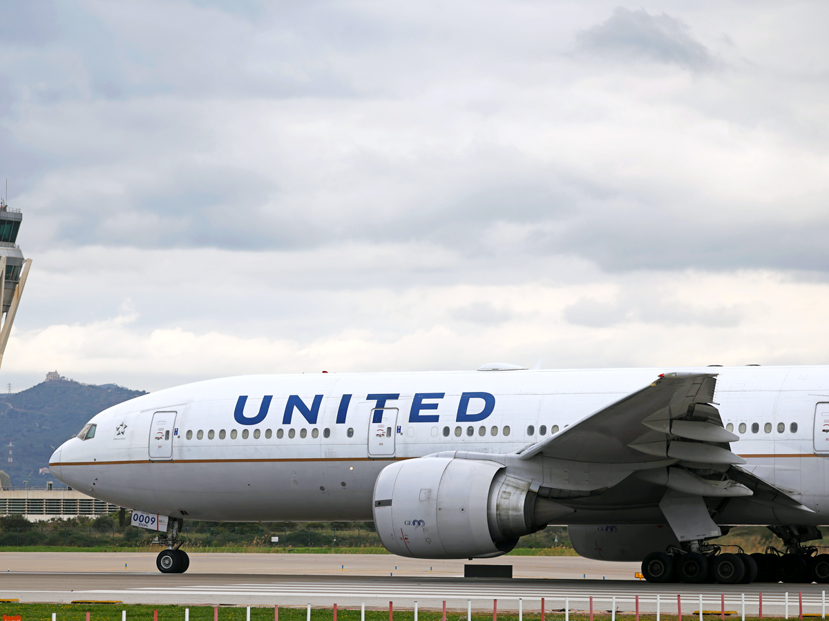 United Airlines Boeing 777 taxiing at airport