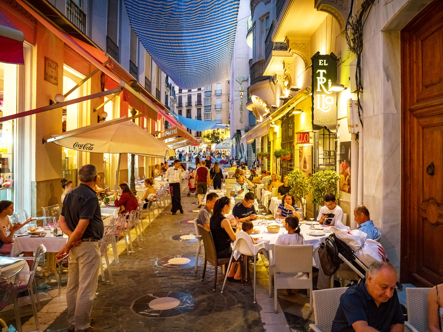 People dining outside late at night in Malaga, Spain