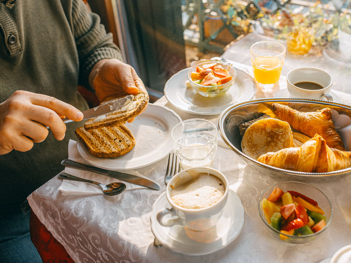 Person eating breakfast pastries