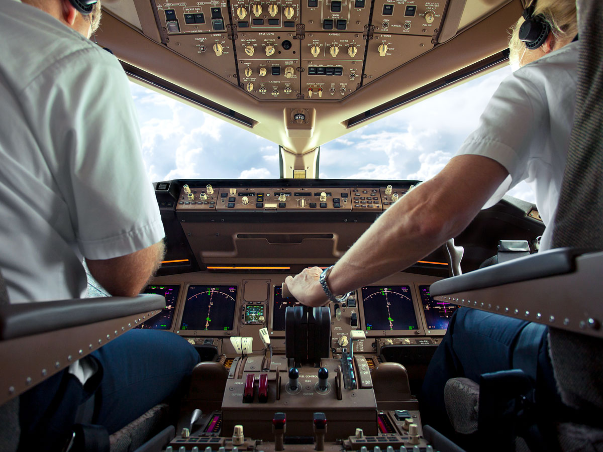 Pilot and co-pilot in airplane cockpit