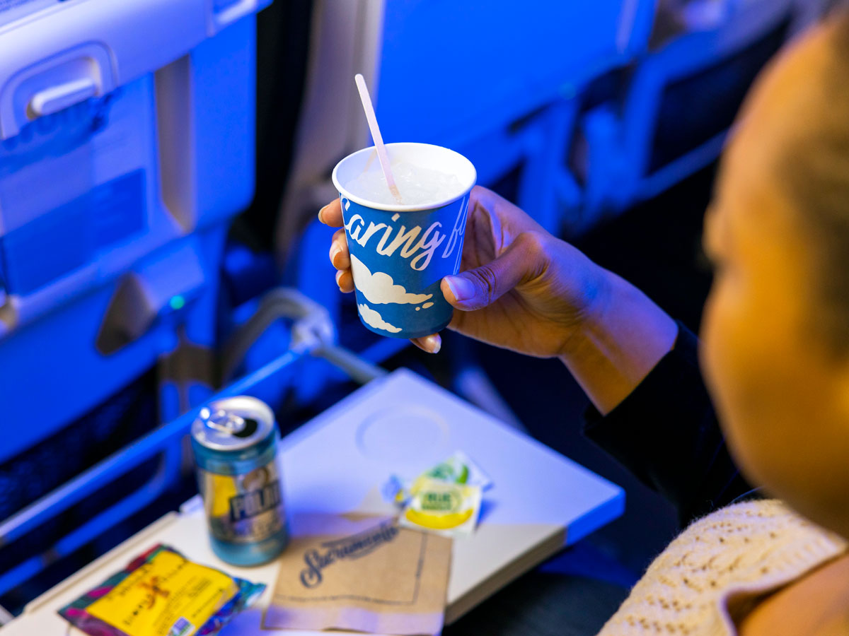 Passenger using paper cup on Alaska Airlines