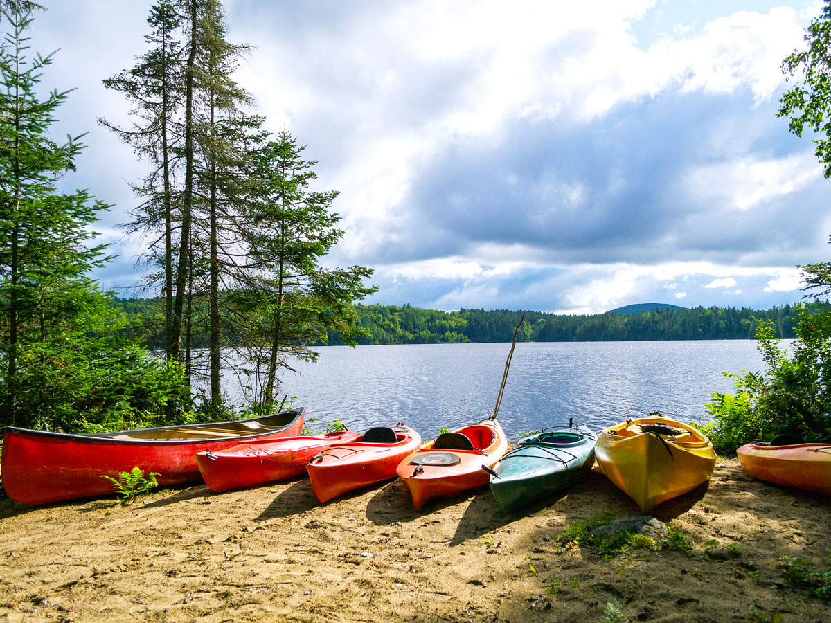 Kayaks on sandy lake shore in the Adirondacks, New York