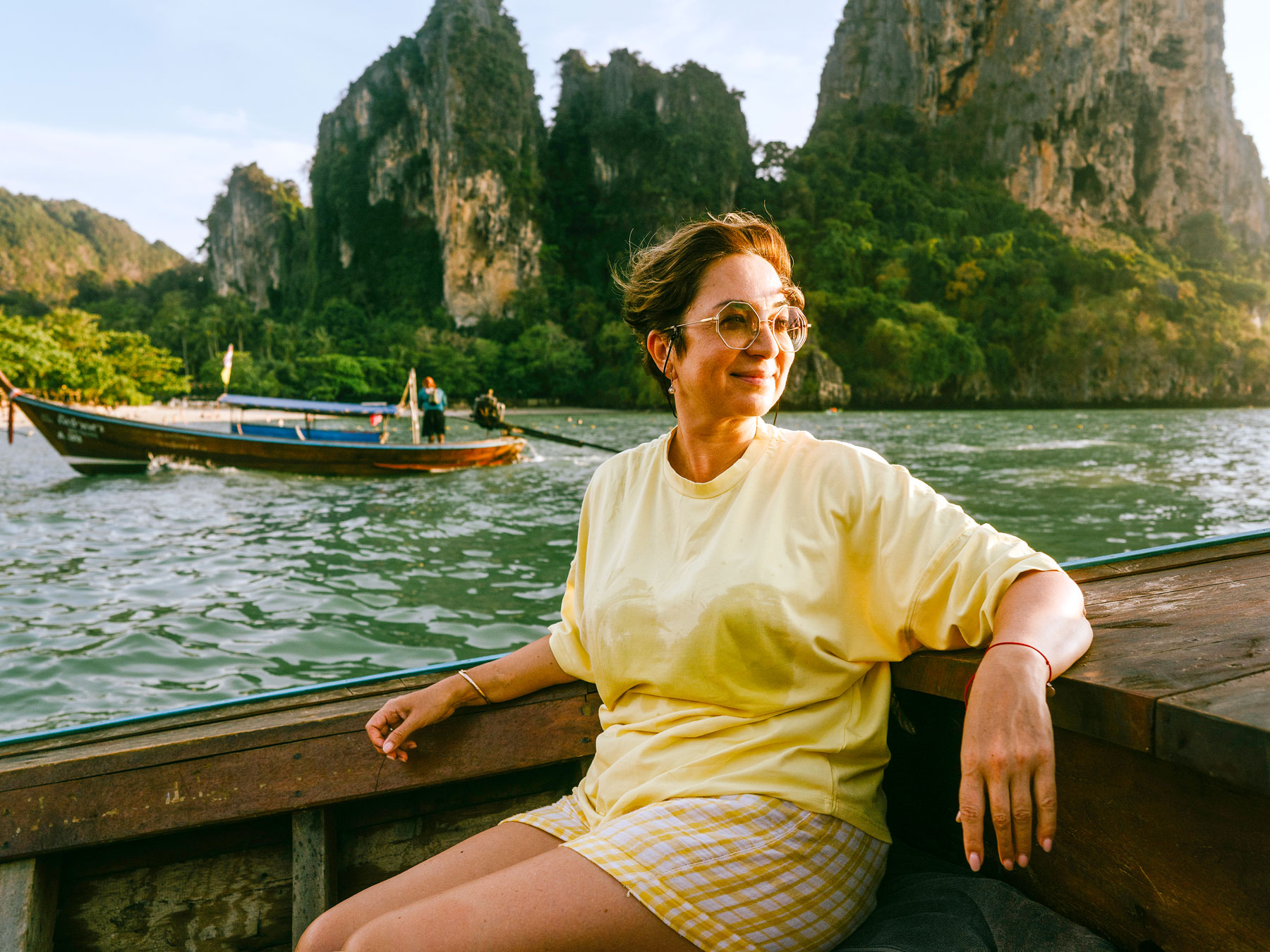 Tourist riding in traditional Thai long-tail boat