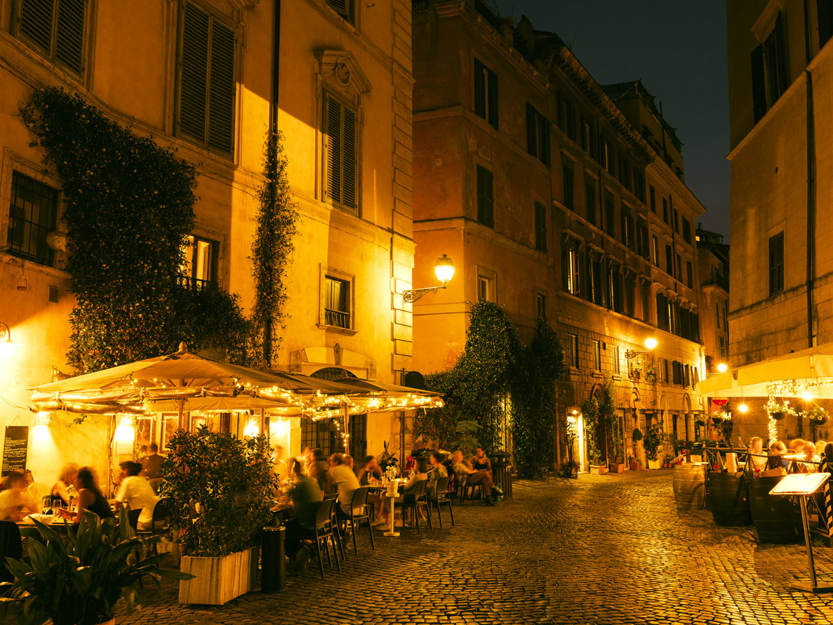 Late-night diners on sidewalks of Rome, Italy