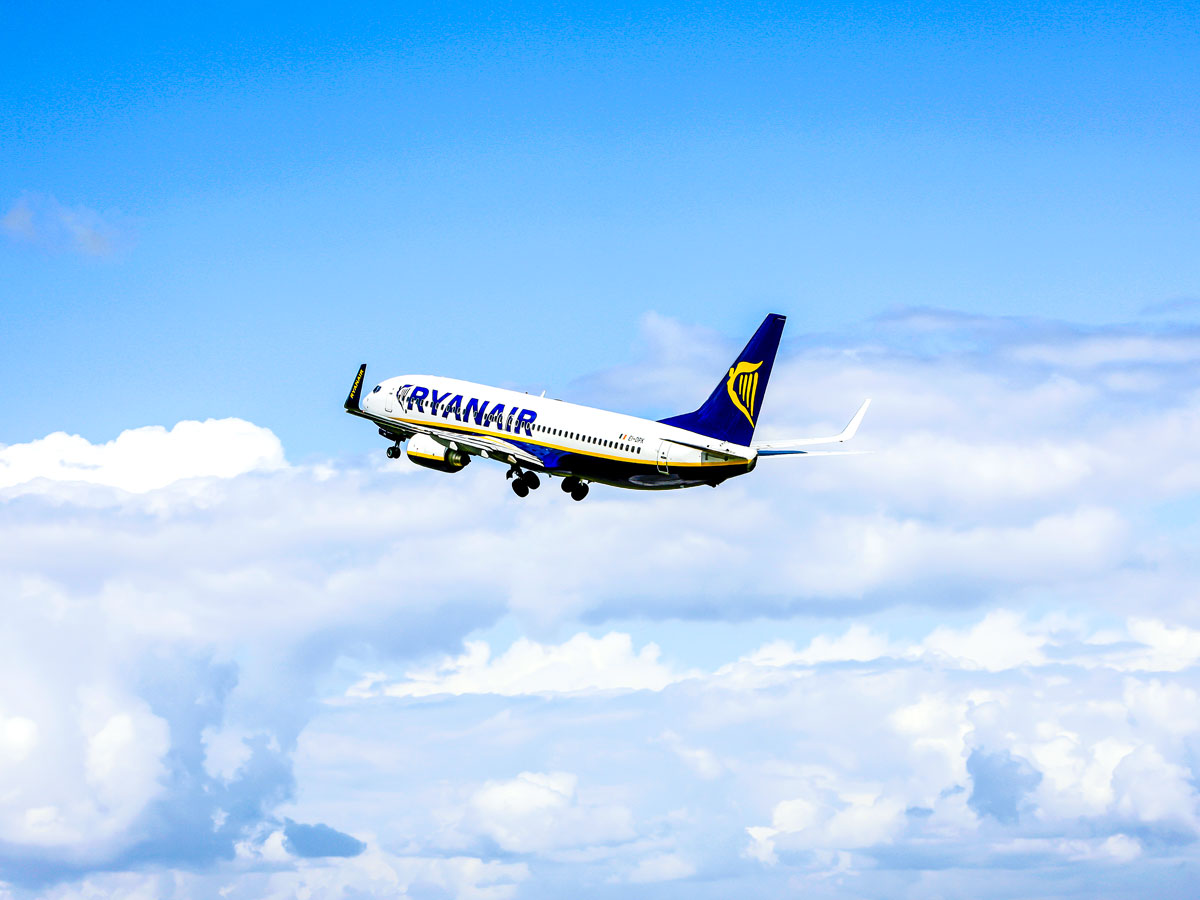 Ryanair Boeing 737 departing into partly cloudy skies