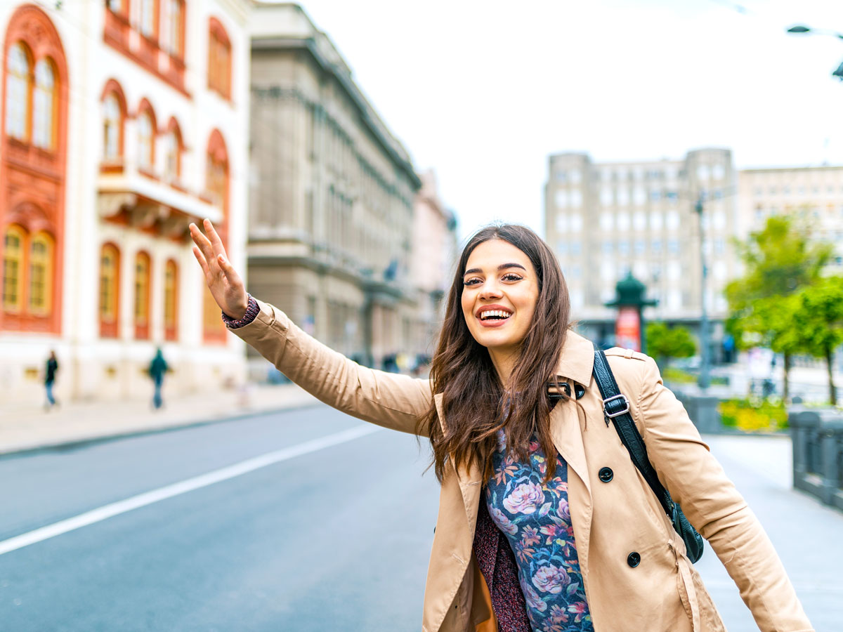 Woman hailing cab on street