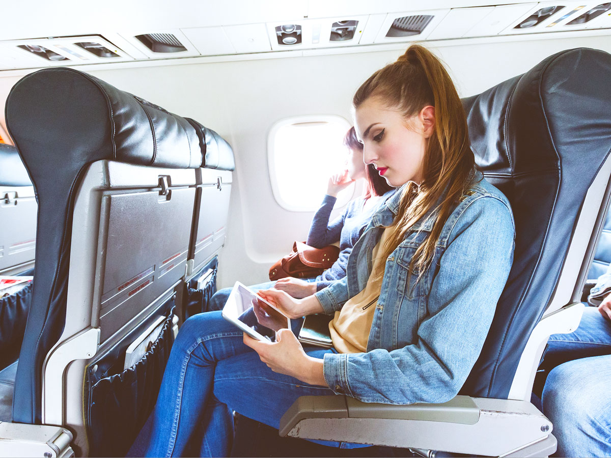 Airline passenger using tablet