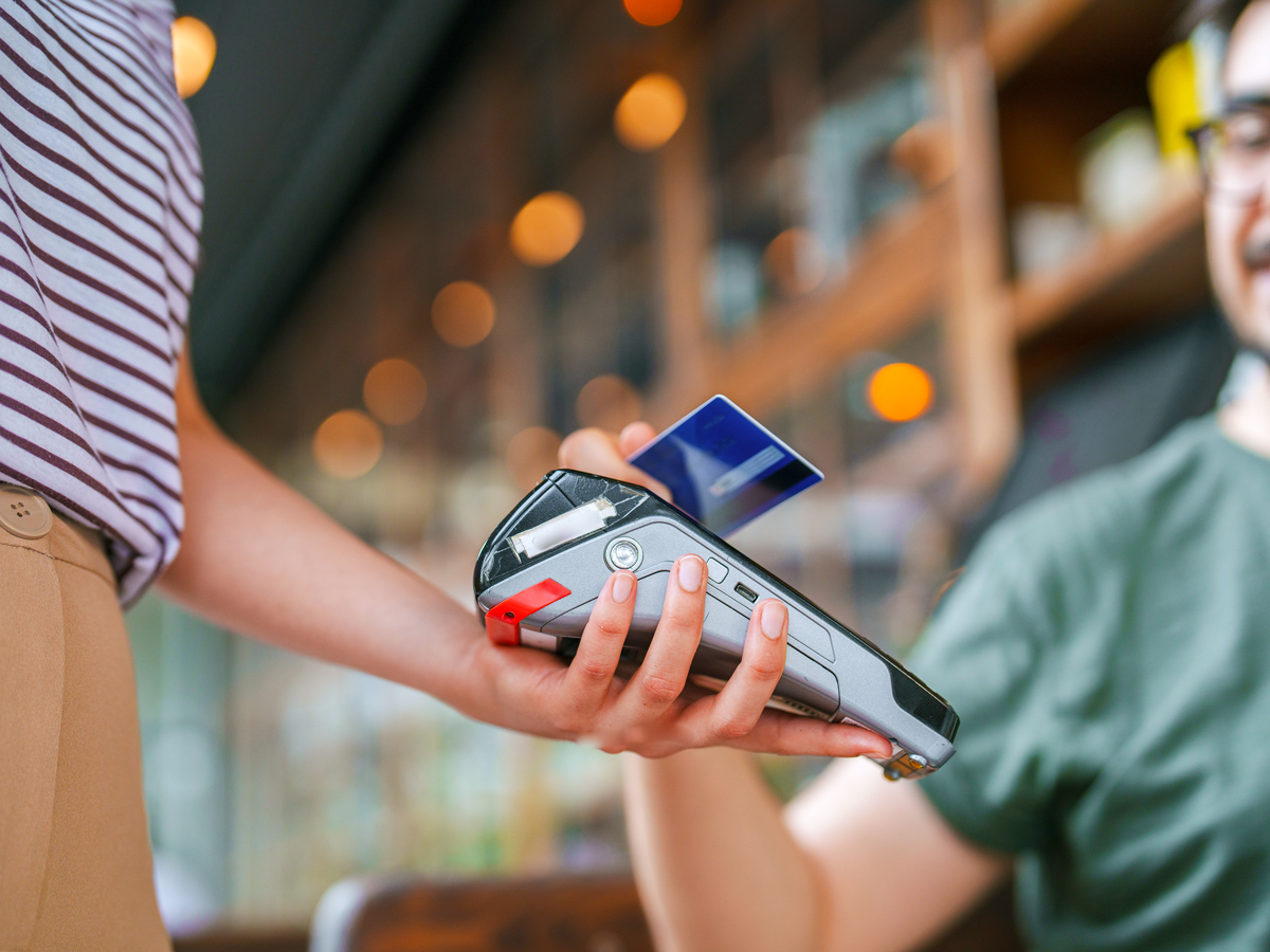 Customer using tap-to-pay on portable machine