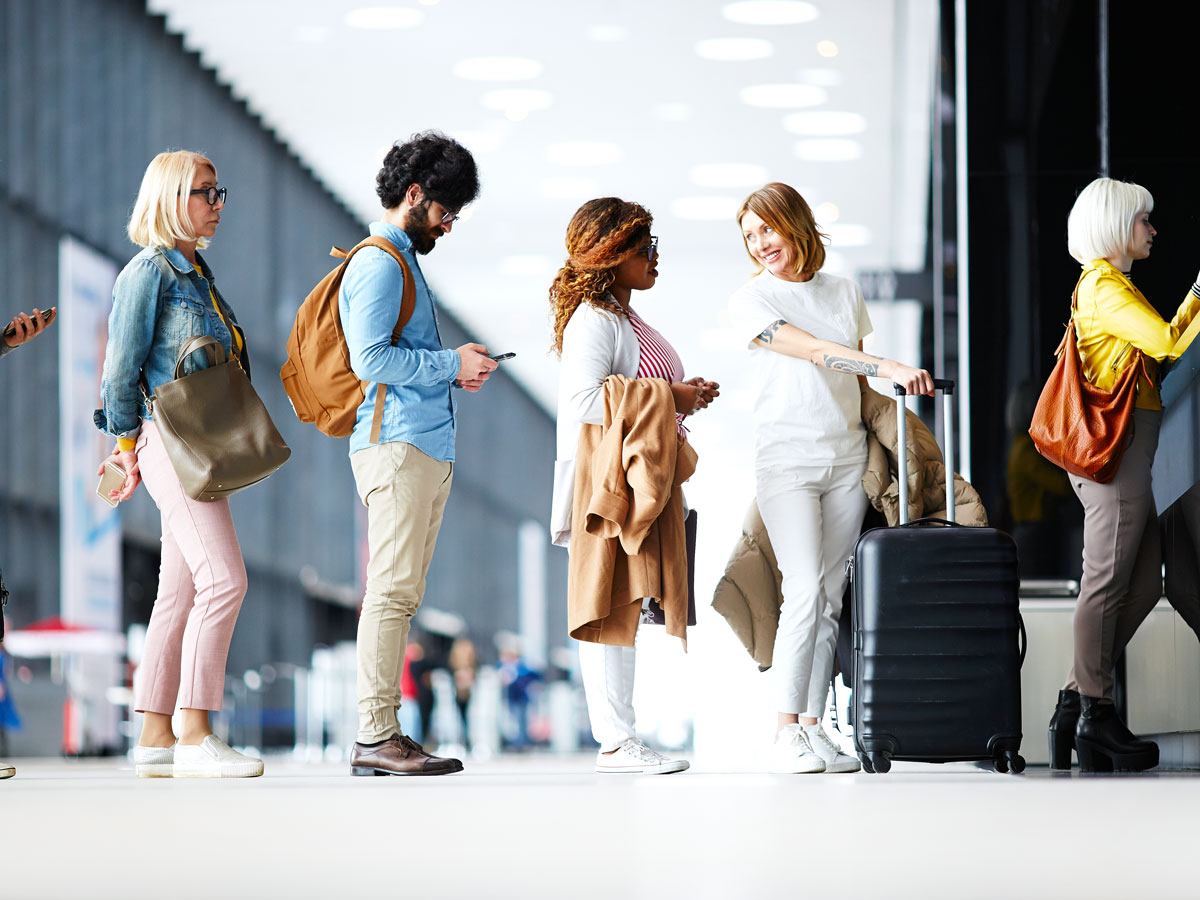 Passengers waiting in line to board airplane