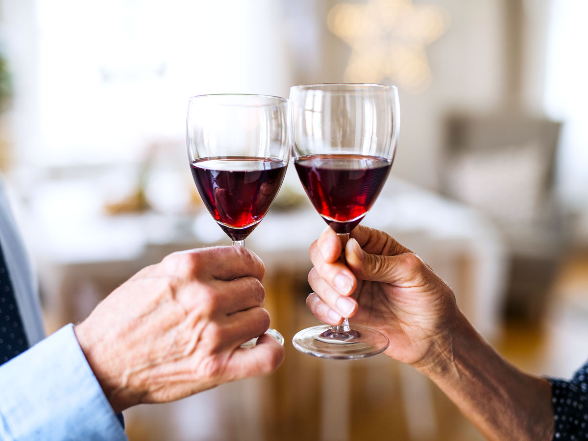 Two people toasting with wine glasses