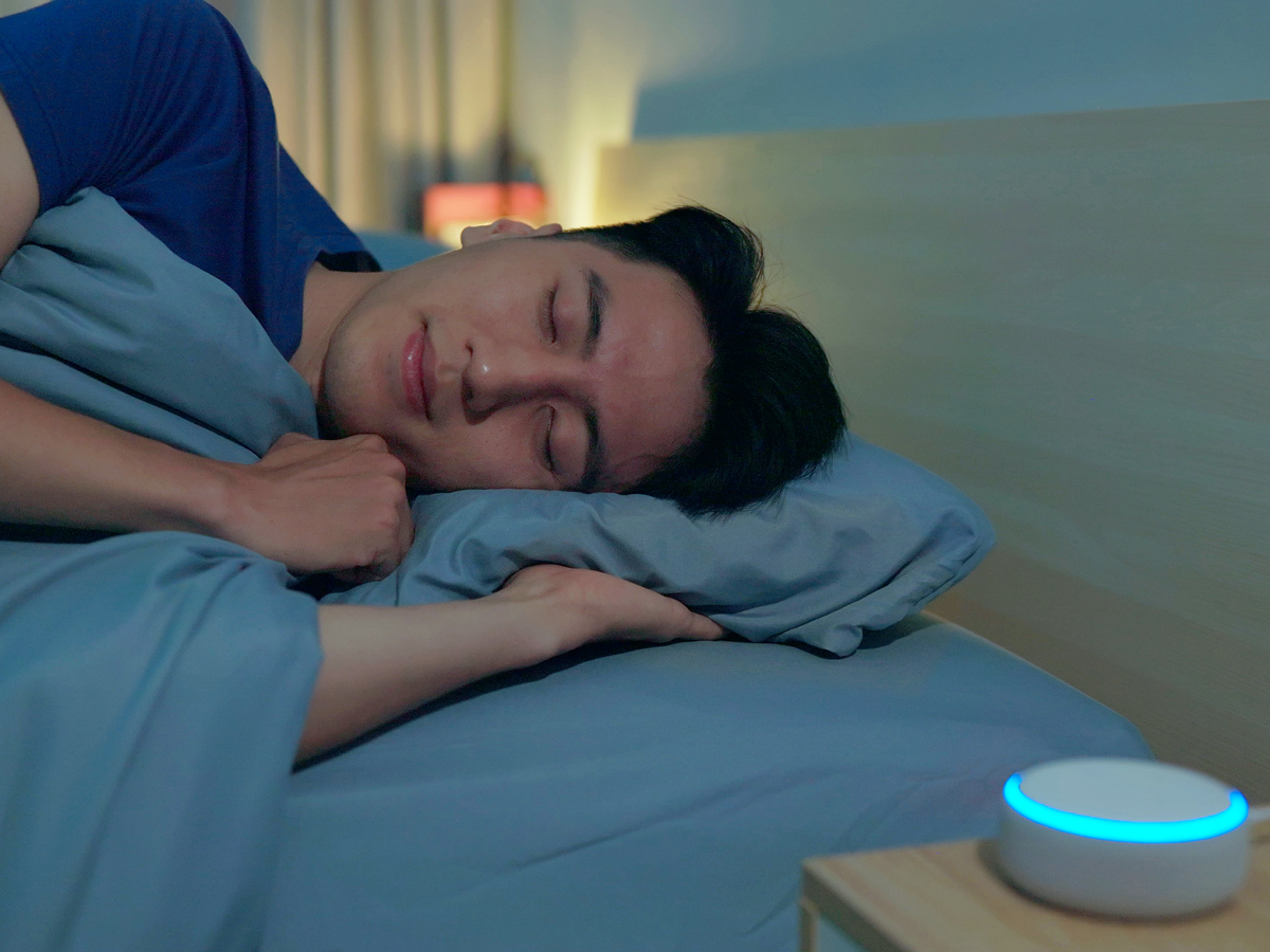 Person sleeping next to sound machine