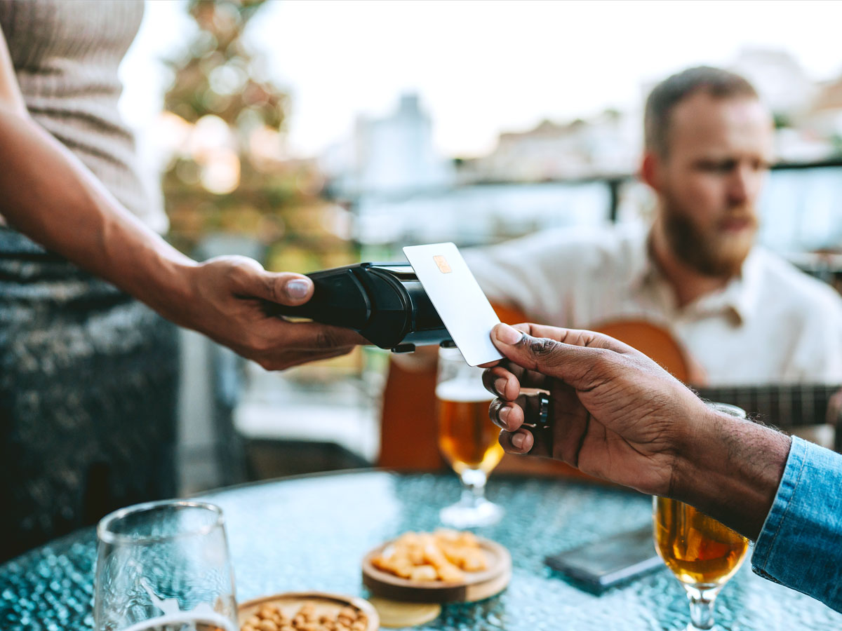 Customer tapping credit card on payment machine