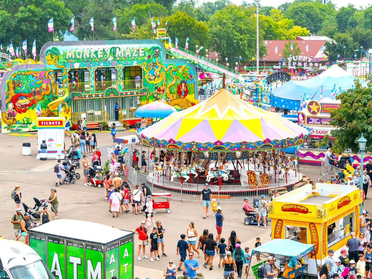 Crowds enjoying amusement park rides at the Great Minnesota Get-Together