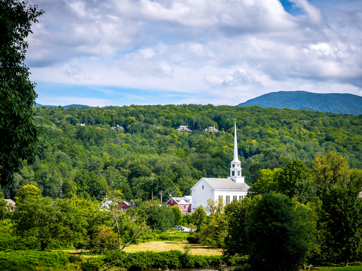 White church tower surrounded by trees in Stowe, Vermont