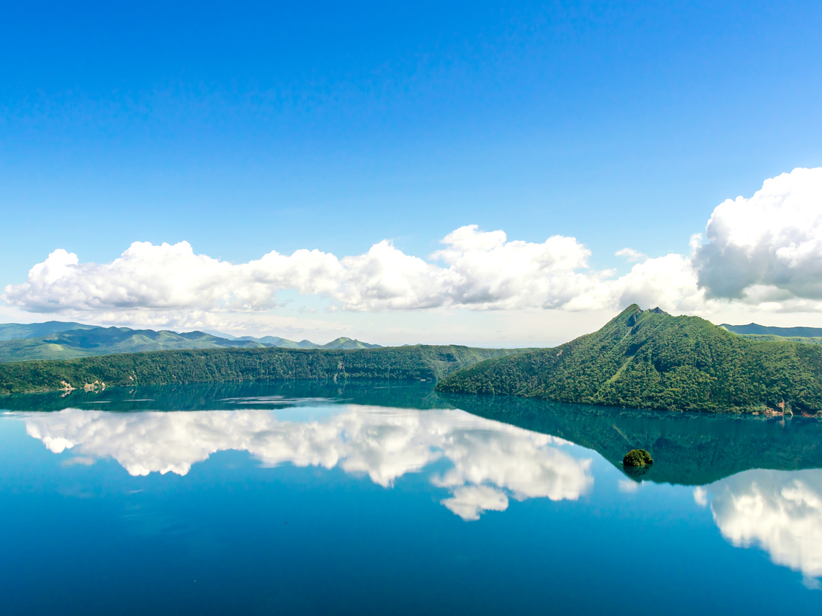 Clouds reflecting on Lake Mashu in Japan